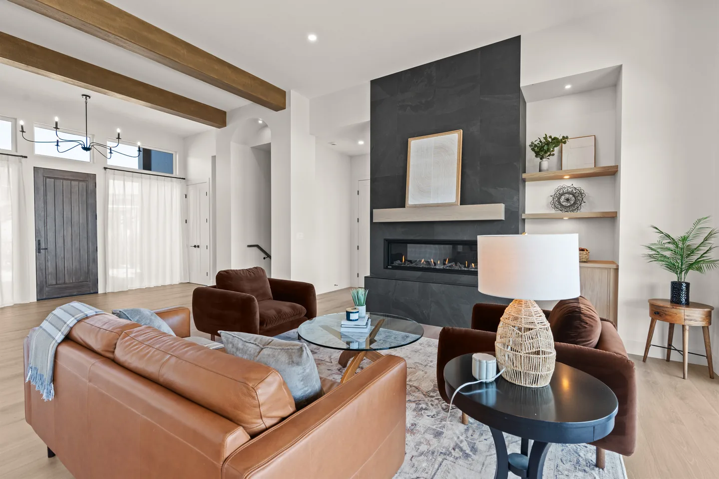 Living room with wood beams looking toward the front entry